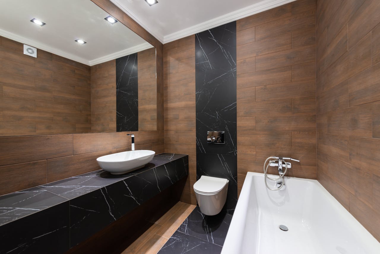 services-01 Modern bathroom with wooden accents, sleek fixtures, and minimalist design.